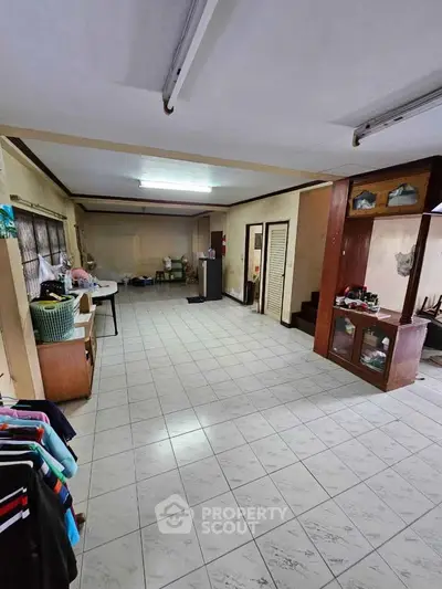 Spacious tiled room with potential for customization, featuring ample natural light and versatile layout.