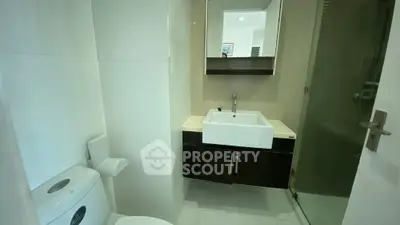 Modern bathroom with sleek sink and glass shower enclosure