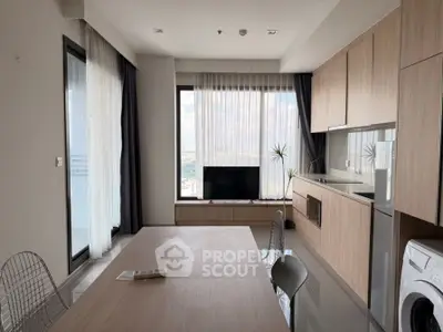Modern kitchen with open layout, sleek cabinetry, and large windows offering stunning city views.