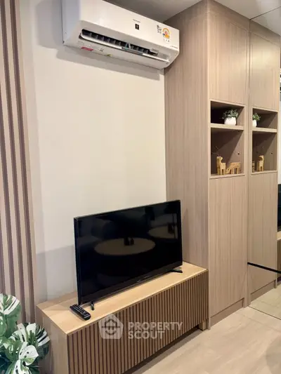 Modern living room with sleek TV setup and stylish wooden cabinetry