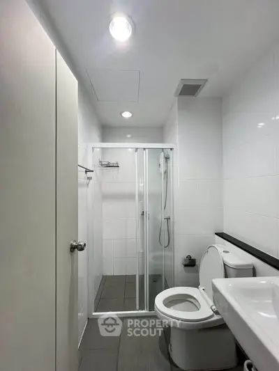 Modern bathroom with shower and sleek fixtures in a contemporary apartment.