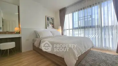 Bright and cozy bedroom with large window and modern decor