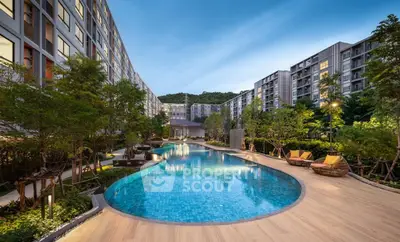 Luxurious residential complex with stunning pool and lush greenery, perfect for relaxation and leisure.