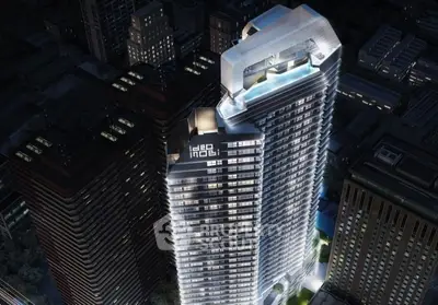 Stunning aerial view of modern high-rise building with illuminated facade in urban skyline.