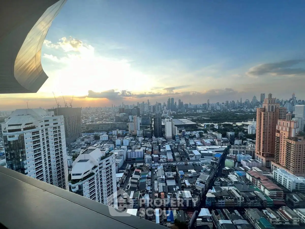 Stunning city skyline view from high-rise balcony at sunset.