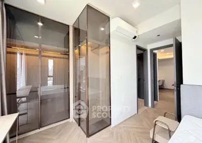 Modern bedroom with glass wardrobe and air conditioning in stylish apartment