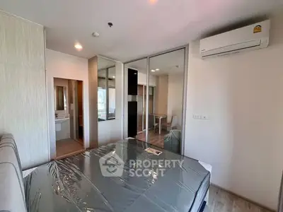 Modern bedroom with mirrored closet and air conditioning in a stylish apartment.