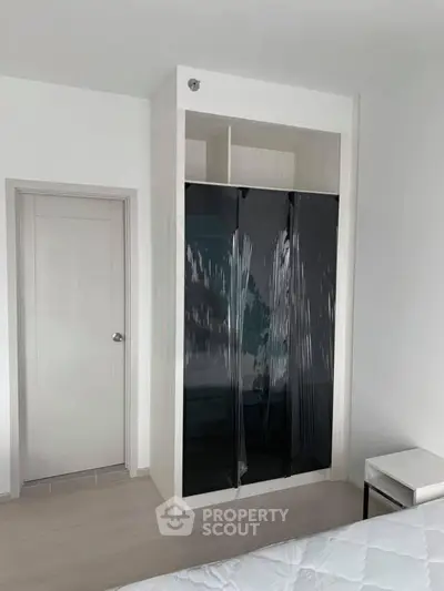 Modern bedroom with sleek built-in wardrobe and minimalist design.
