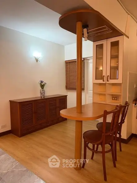 Charming dining nook with wooden furniture and cozy lighting in a modern apartment.