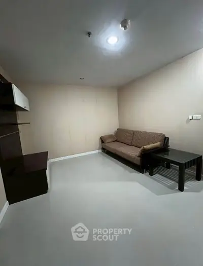 Cozy living room with modern sofa and sleek furniture in a minimalist design.