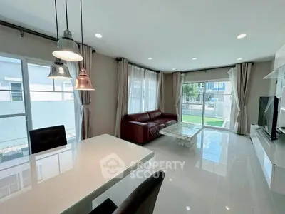 Spacious modern living room with large windows and elegant furnishings