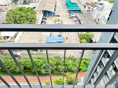 Stunning high-rise balcony view overlooking urban landscape and greenery.