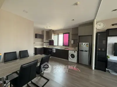 Modern kitchen and dining area with sleek appliances and stylish decor