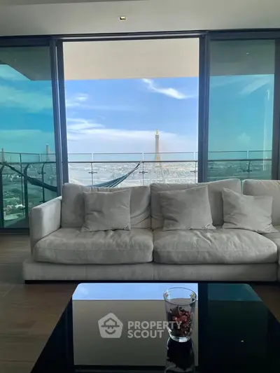 Luxurious living room with stunning city view and spacious balcony, perfect for relaxation and entertainment.