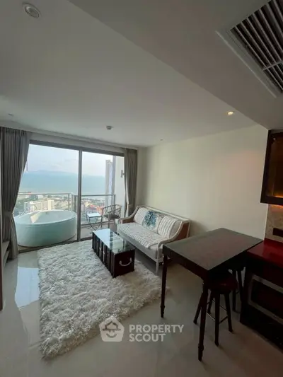 Modern living room with stunning ocean view and cozy balcony