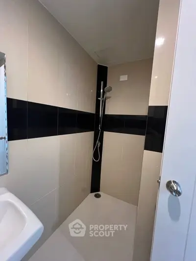 Modern bathroom with sleek shower design and neutral tiles