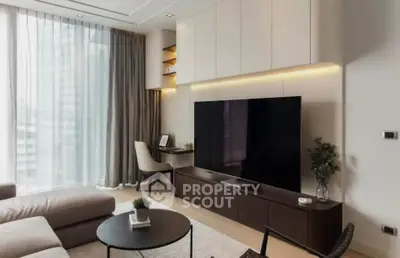 Modern living room with large TV, stylish furniture, and floor-to-ceiling windows.