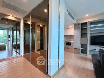 Spacious modern living room with mirrored closets and open kitchen layout