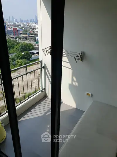 Modern balcony with city view and drying rack, perfect for urban living.