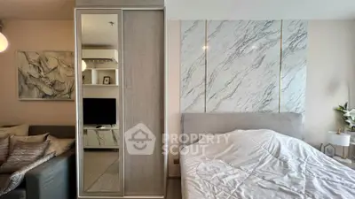 Stylish bedroom with modern decor and mirrored wardrobe in a cozy apartment