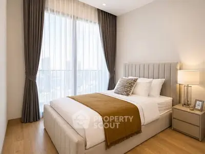 Elegant bedroom with large window and stylish decor in modern apartment.