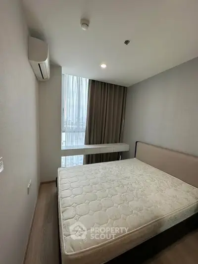 Modern bedroom with large window and minimalist design