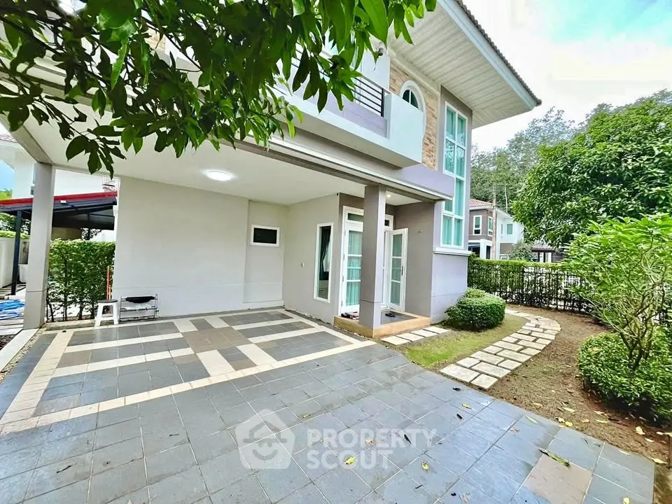 Charming two-story home with spacious driveway and lush garden, perfect for family living.
