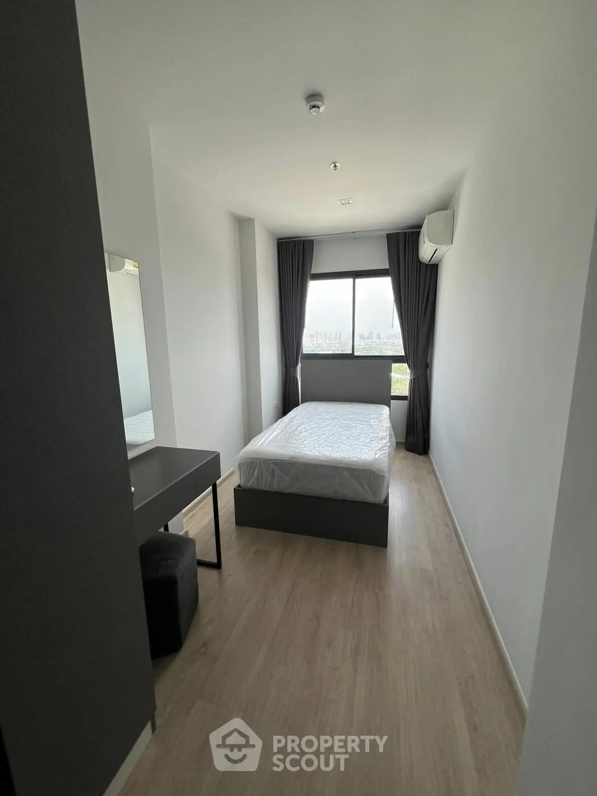 Modern minimalist bedroom with large window and sleek furnishings