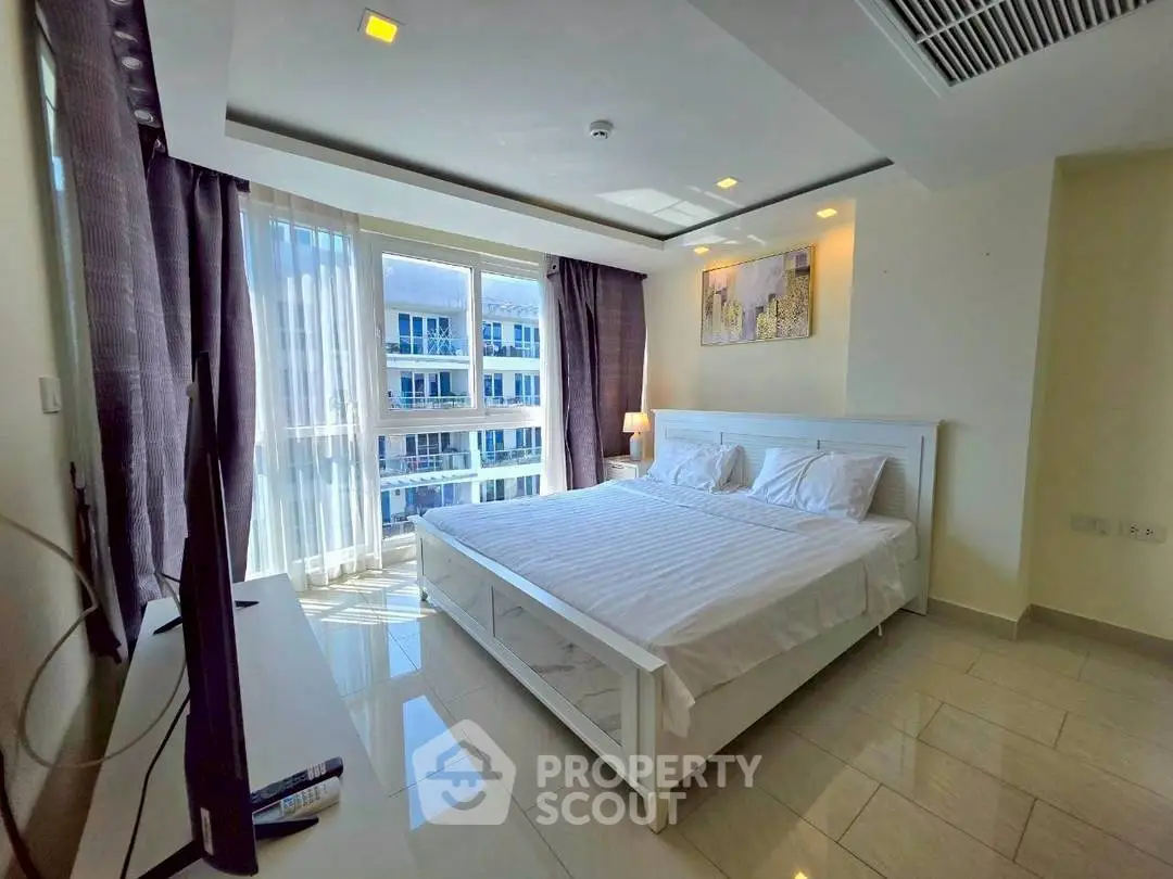 Bright and spacious bedroom with modern decor and large windows offering a stunning view.