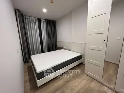 Modern minimalist bedroom with sleek design and ample natural light.
