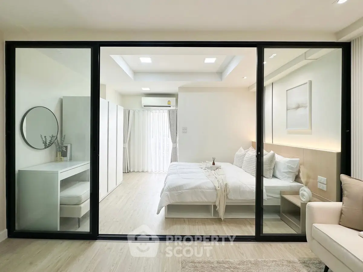 Modern bedroom with glass partition and elegant decor