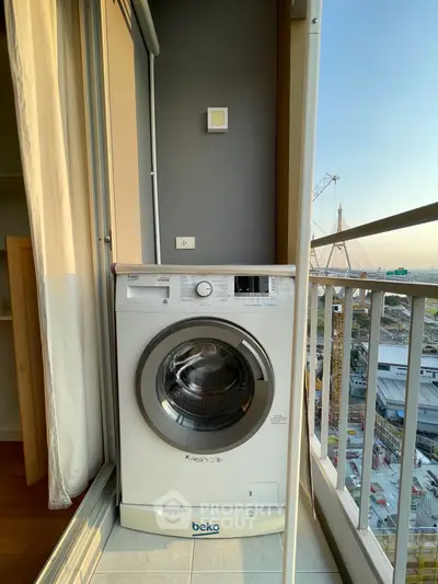 Modern balcony with washing machine and stunning city view, perfect for urban living convenience.