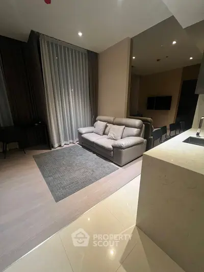 Modern living room with sleek furniture and open kitchen layout