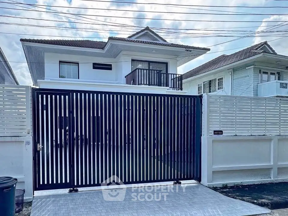 Modern two-story house with gated entrance and sleek design
