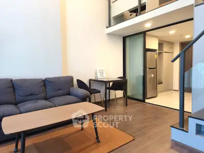 Modern loft-style living room with mezzanine and sleek furnishings