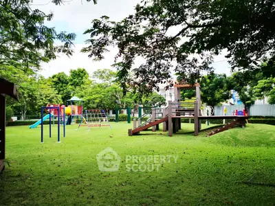 Charming residential playground with lush greenery and modern play equipment, perfect for family-friendly living.