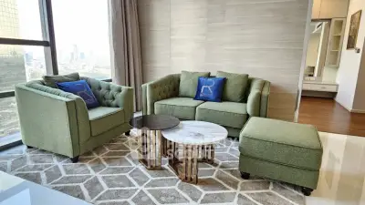 Stylish modern living room with green furniture and city view