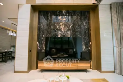 Luxurious living room with elegant marble feature wall and modern TV setup