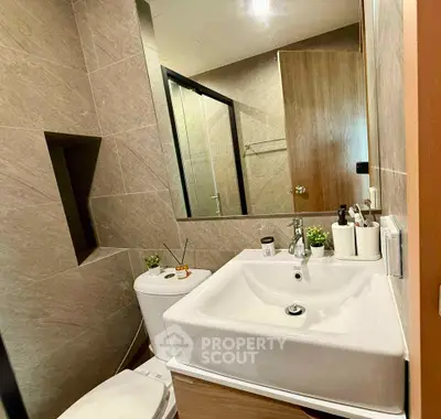 Modern bathroom with sleek sink and stylish tiles, perfect for contemporary living.