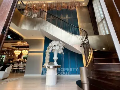 Luxurious modern living room with elegant staircase and stylish decor