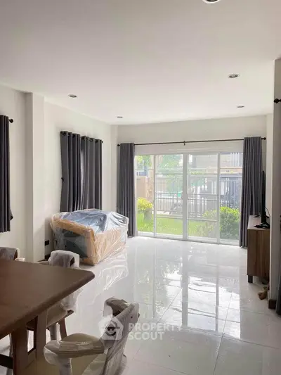 Spacious living room with large windows and modern furniture in a bright, airy home.