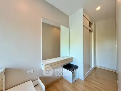 Modern bedroom with sleek built-in wardrobe and vanity in a bright, minimalist design.