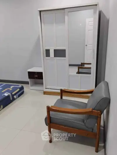Modern bedroom with sleek wardrobe and stylish chair