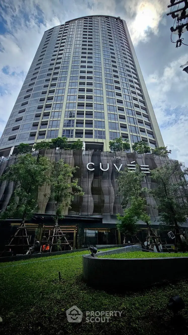 Stunning modern high-rise building with lush greenery and unique architectural design.