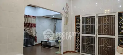 Spacious living area with elegant decor and large windows for natural light.