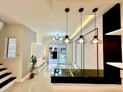 Modern open-concept living space with stylish lighting and sleek design