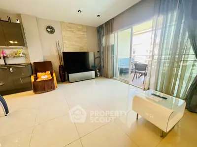 Spacious living room with modern decor and large balcony access, perfect for relaxation and entertainment.