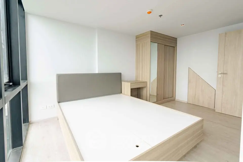 Spacious modern bedroom with large windows and minimalist design