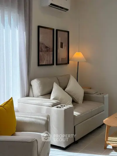 Cozy living room with modern beige sofa, stylish decor, and soft lighting, perfect for relaxation.