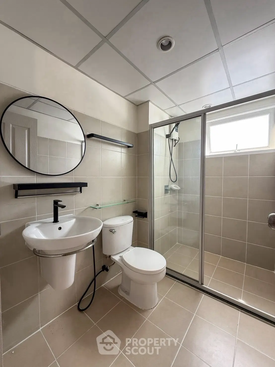 Modern bathroom with sleek fixtures and spacious shower in a contemporary home.